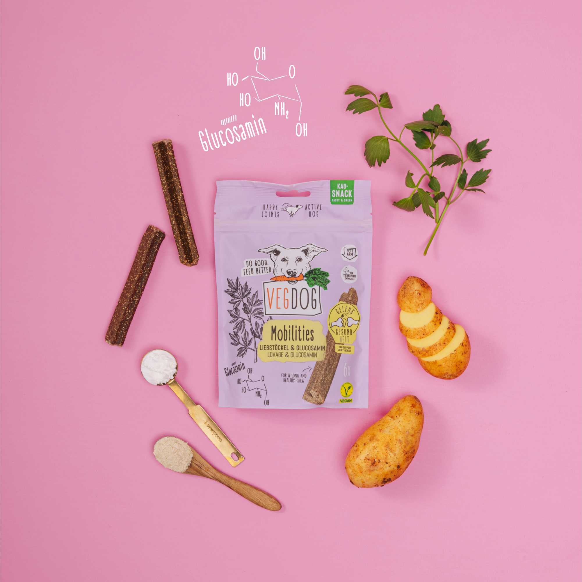 Vedog pet product packaging with treats and a spoon on a pink background