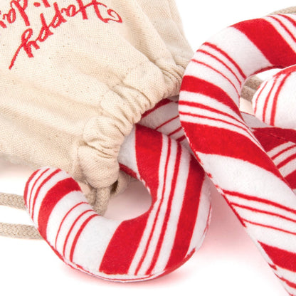 Red and white striped candy canes with a beige fabric background