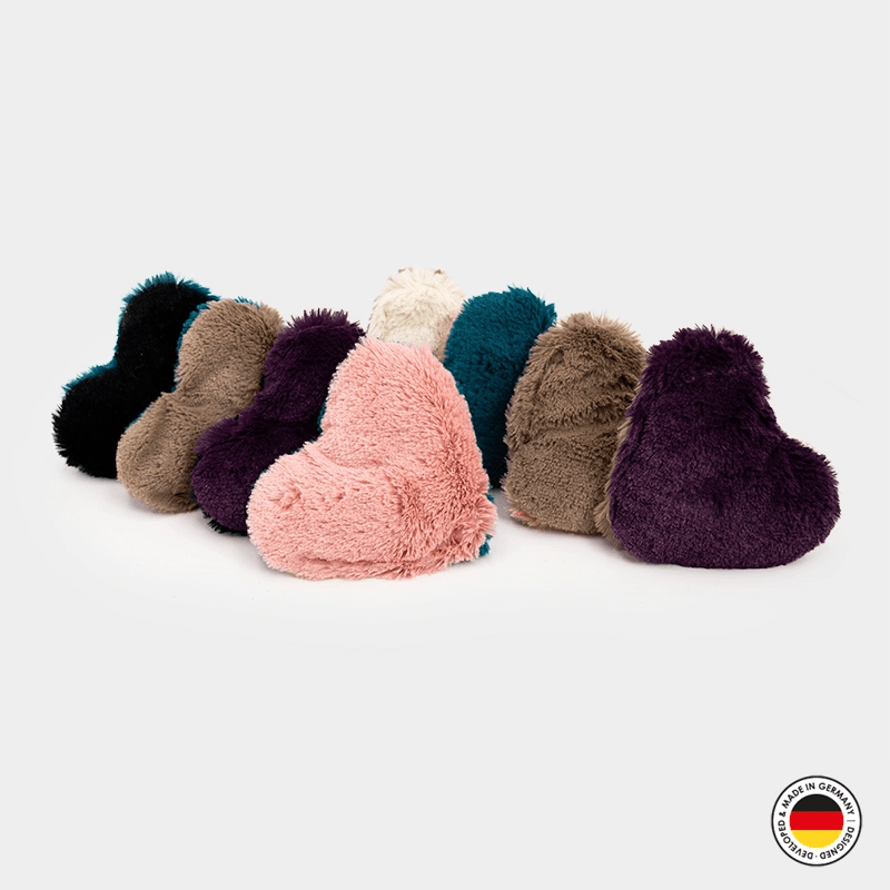Set of colorful fluffy heart-shaped cushions on a white background