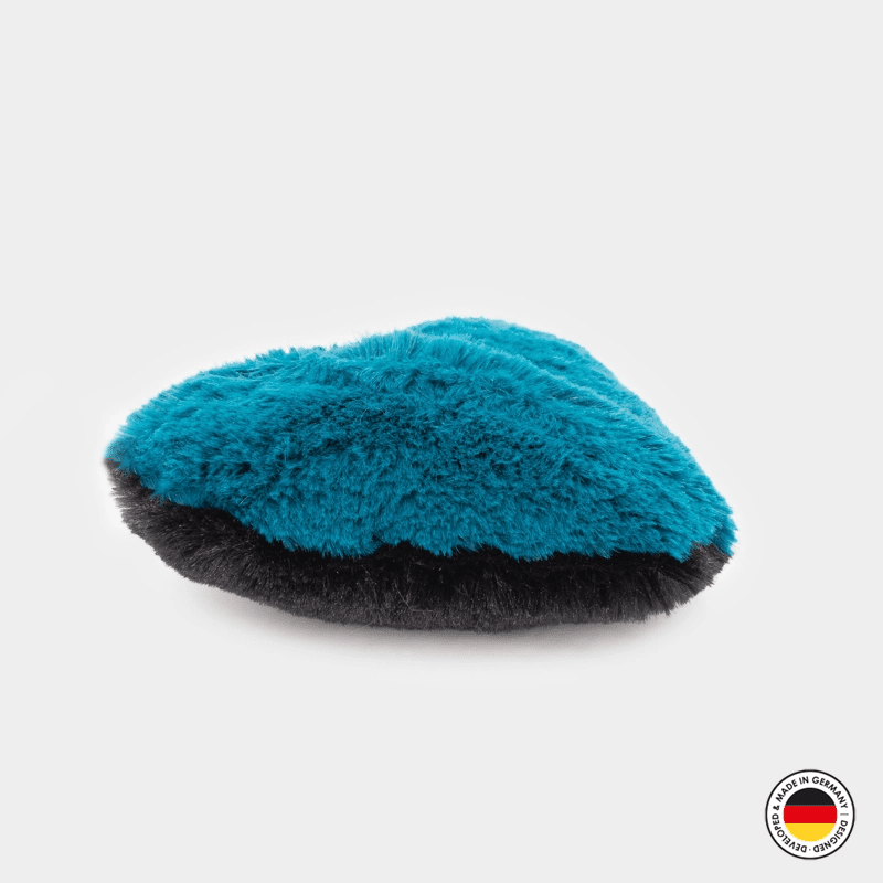 Blue and black grooming brush on a white background
