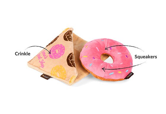 Two dog toys shaped like a slice of pizza and a donut with crinkle and squeaker features labeled.