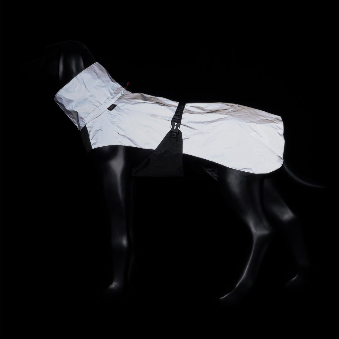 White raincoat on a black mannequin against a black background