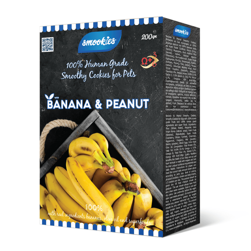 Æske med smookies banan- og jordnøddesmåkager til kæledyr på hvid baggrund