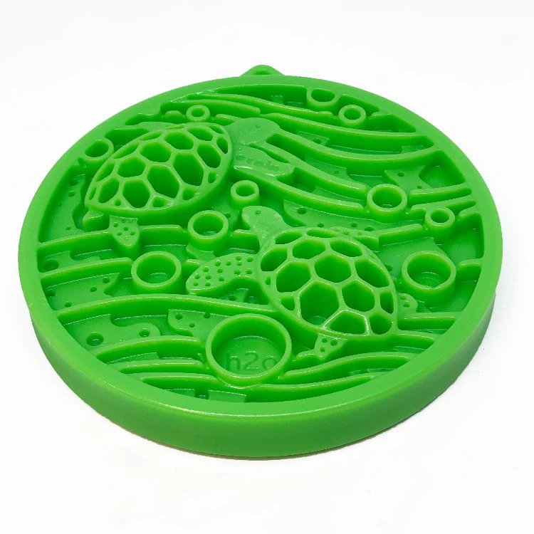 Green silicone mold with turtle design on a white background
