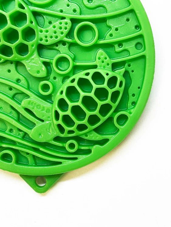 Green silicone mat with turtle design on a white background