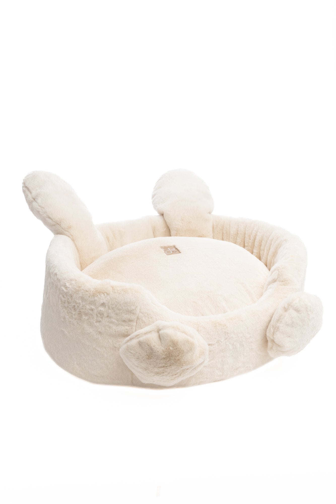 White plush pet bed with bunny ears and feet on a white background