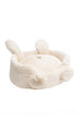 White plush pet bed with bunny ears and feet on a white background