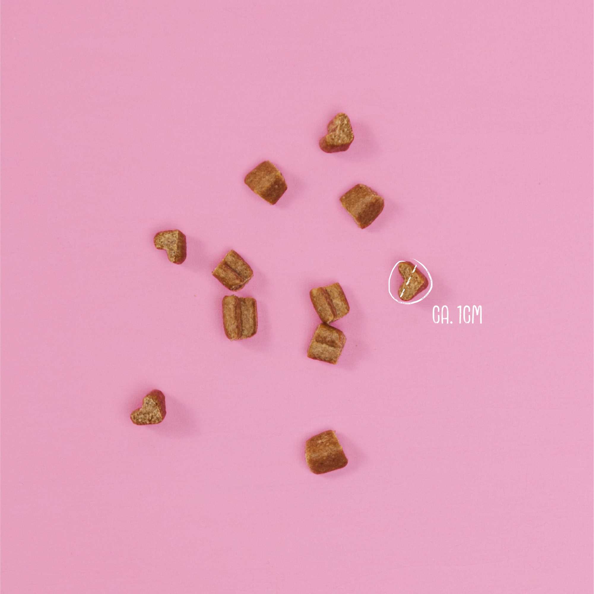Dog treats on a pink background with a weight indicator.
