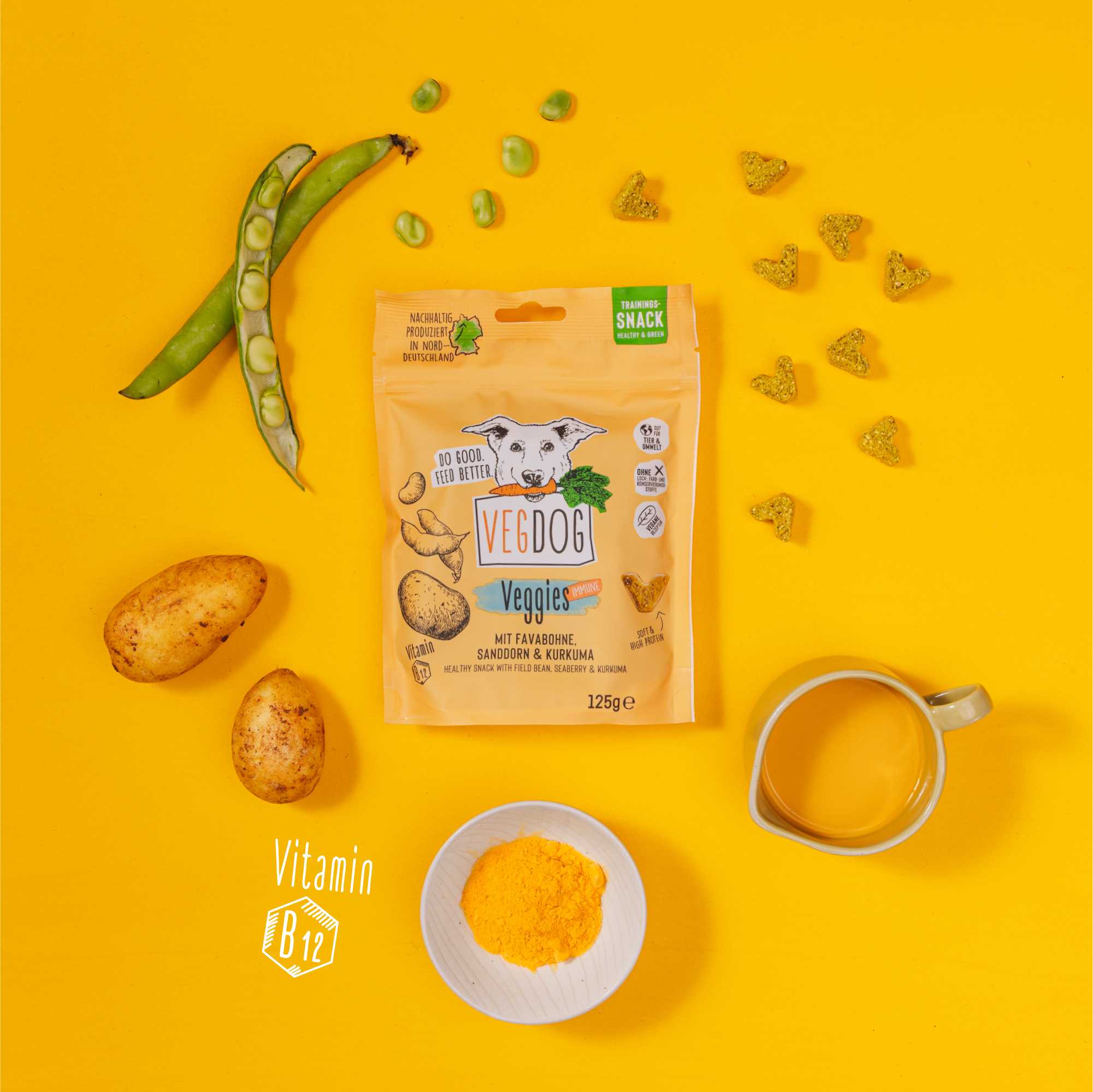Vedog Veggie snack package on a yellow background with vegetables and a cup.