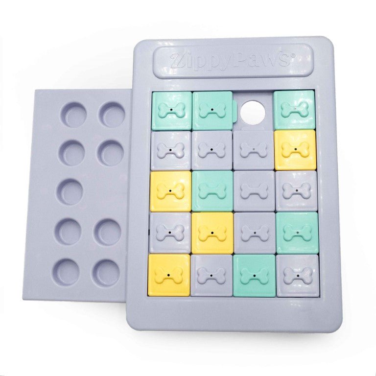 Silicone mold with bone-shaped cavities in pastel colors on a white background