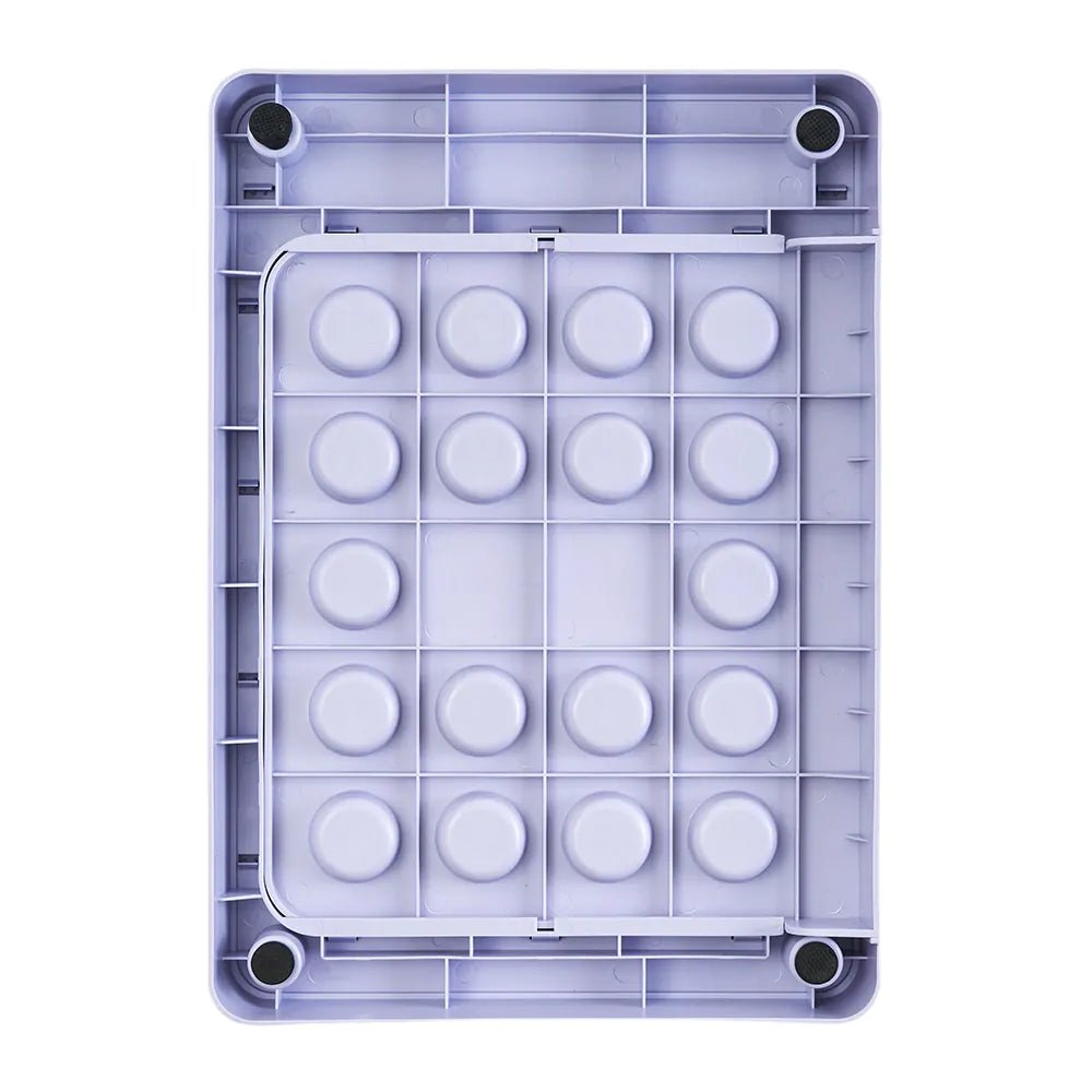Purple ice cube tray with circular molds on a white background